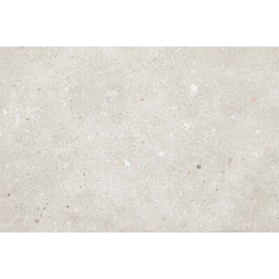 Primer plano de un azulejo rectangular Glamstone White, con una base clara de efecto piedra y salpicado de pequeños fragmentos de colores.