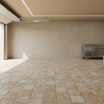 Suelo de porcelánico beige rústico en garaje con coche blanco y armario metálico.