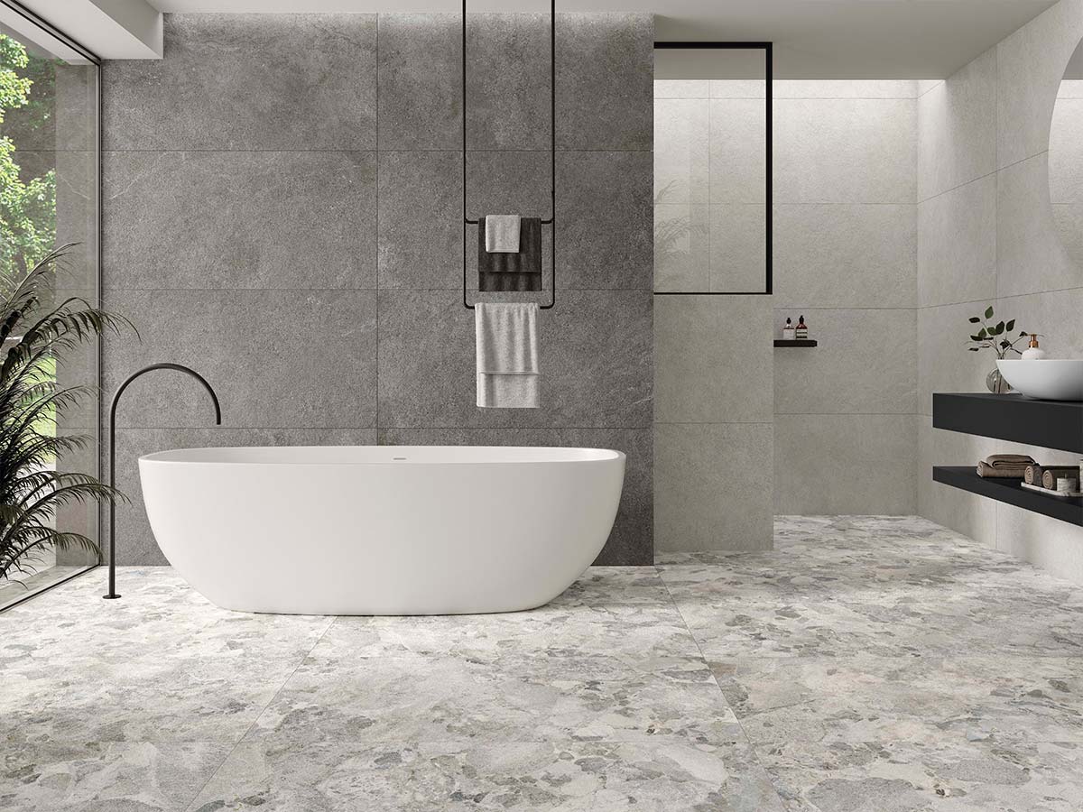 Baño moderno con suelo y paredes de porcelánico efecto piedra, ideal por su resistencia al agua