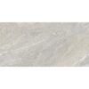 Azulejo Sakhir Grey con efecto piedra, mostrando una base gris con variaciones tonales y finas vetas blancas.