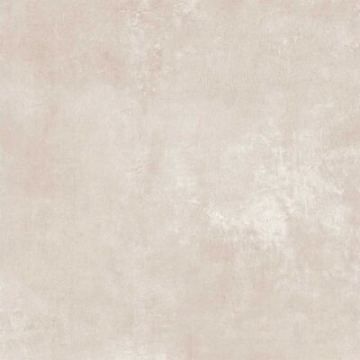 Primer plano de azulejo beige con textura de cemento. Se aprecian matices rosados y el acabado indeed sand.