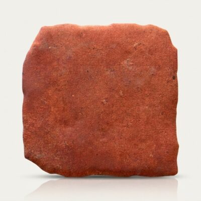 Azulejo porcelánico efecto barro natural Benisa Cotto de color terracota con bordes irregulares.