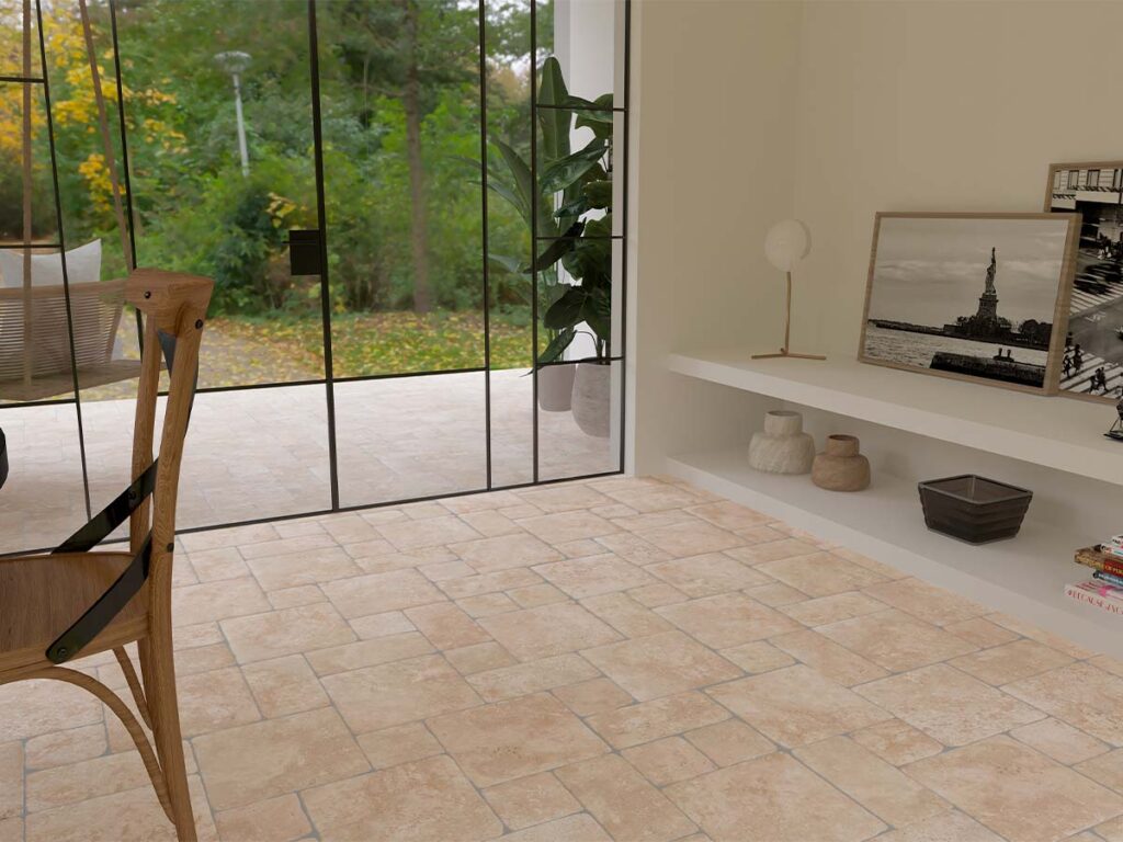 Salón con suelo rústico interior de baldosas de barro en tonos claros y grandes ventanales al jardín.