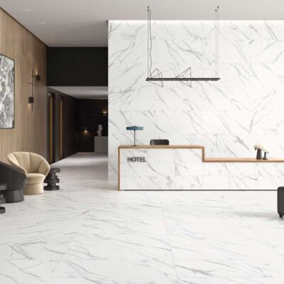 Lobby de hotel con suelos y paredes de porcelánico efecto mármol