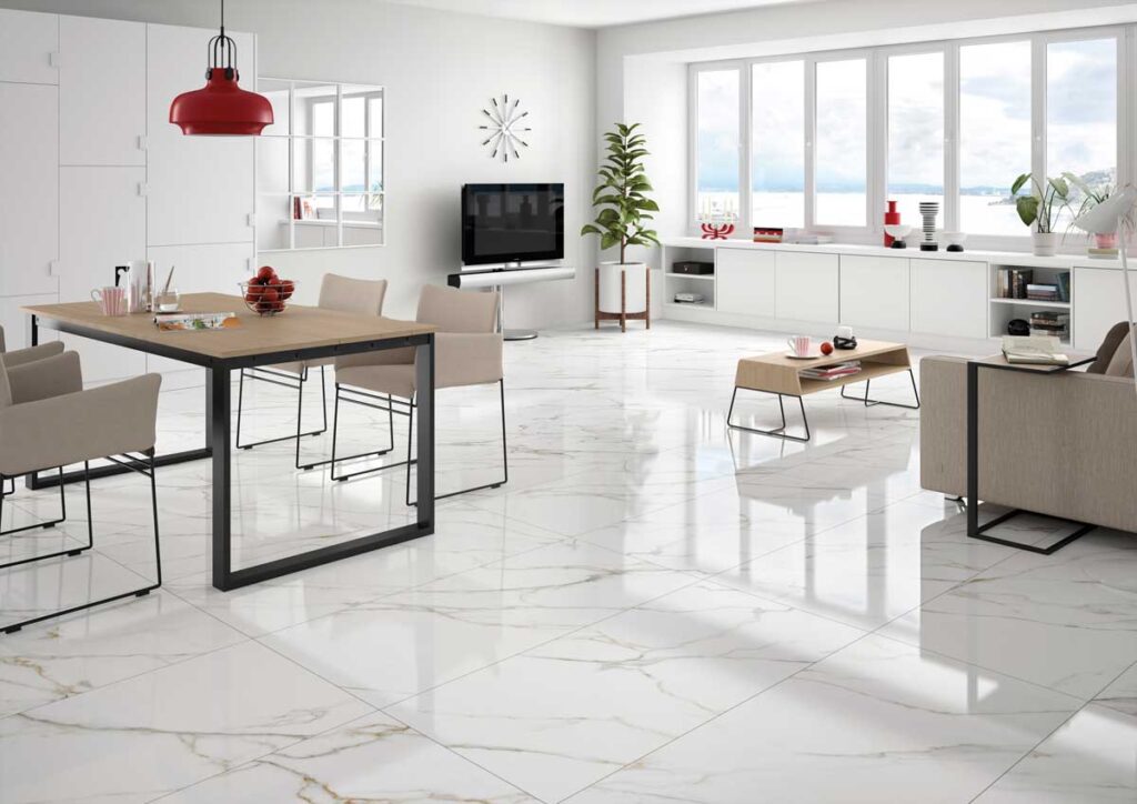 Sala de estar y comedor moderna con suelos porcelánicos blancos de vetas doradas. El acabado pulido refleja la luz.