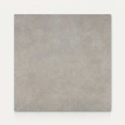 Azulejo porcelánico cuadrado gris con textura de cemento sobre fondo blanco.