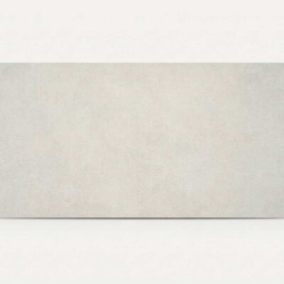 Azulejo porcelánico rectangular de imitación cemento en tono perla claro.