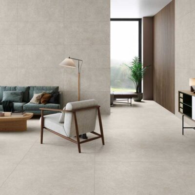 Salón moderno con suelo porcelánico efecto piedra Lomma Bone y paredes