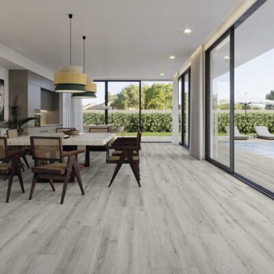 Moderno comedor con suelo porcelánico efecto madera Concorde Grey. Grandes ventanales dan a una piscina.