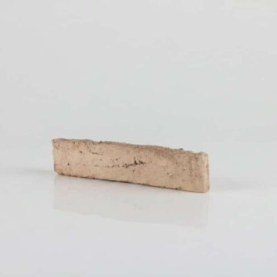 Pieza rectangular de baldosa cerámica con acabado enarenado en tonalidad salmón, superficie texturizada y mate, presentada sobre fondo neutro.