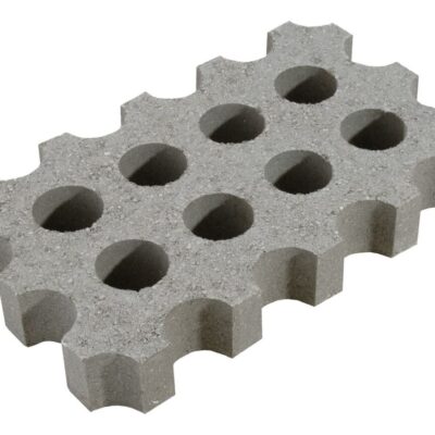 Pieza de hormigón aligerado con patrón de orificios circulares distribuidos uniformemente. Acabado gris claro, bordes con dentellón characteristic, textura rugosa de material hormigonado.