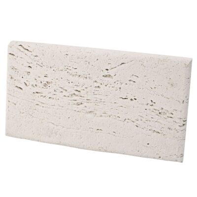 Pieza rectangular de aplacado porcelánico con efecto travertino blanco crudo. Superficie con textura rústica y veteado natural en tonos beige y gris claro, acabado mate.