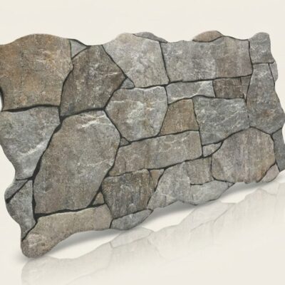 Plaqueta irregular de azulejo con efecto piedra natural en tonos grises. Las piezas presentan bordes irregulares y textura rugosa característica, combinando módulos de diferentes tamaños para un acabado rústico y suelo cerámico versátil.