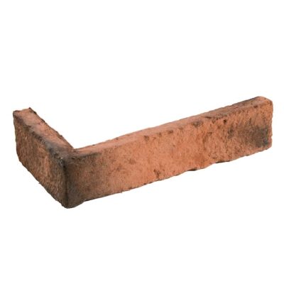 Pieza de aplacado en forma de esquina, de hormigón con textura imitación ladrillo, tonos rojizos y ocres con acabado rústico mate. Perfil angular para remate de bordes en revestimientos de pared.