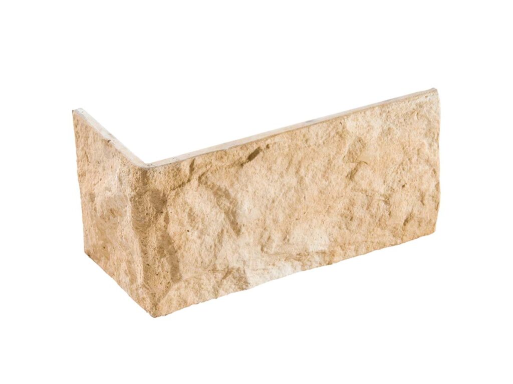 Pieza angular de revestimiento con textura rústica en tonos beige y gris claro, acabado mate imitando piedra natural.