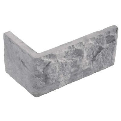 Pieza angular de aplacado con textura de piedra natural en tonos grises. Formato rectangular irregular con acabado rústico y superficie rugosa que imita la piedra canteada.