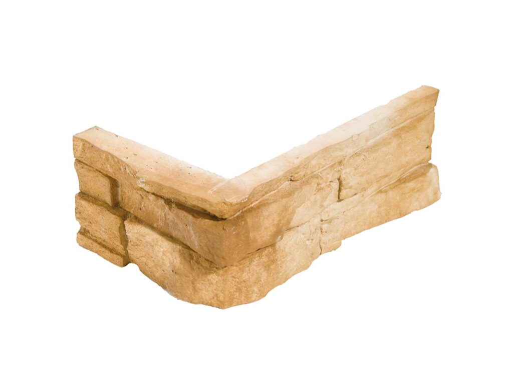 Pieza de esquina en formato angular para revestimiento con efecto piedra natural, textura rugosa en tonos avellana cálidos y acabado mate rústico.