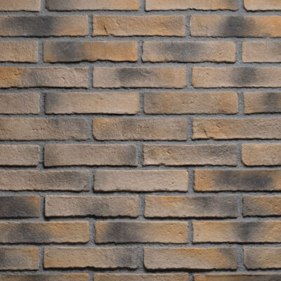 Superficie con textura de ladrillo visto en tonos cálidos beige, marrón y gris, mostrando el acabado rústico característico de la imitación ladrillo oxford bristol con juntas de mortero visible.