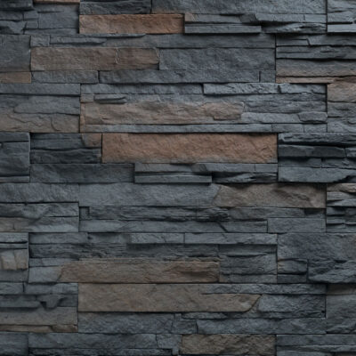 Superficie de aplacado con textura de piedra natural en tonos gris oscuro y marrón, con acabado mate y relieve irregular que imita la piedra volcánica Varadero.