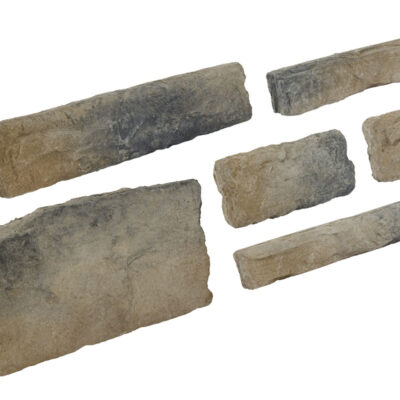 Seis piezas de revestimiento de hormigón con acabado rústico en tonos grises y beige. Incluye una pieza rectangular grande, cuatro cilindros pequeños y una pieza cuadrada, todas con textura de piedra natural sin pulir y superficie rugosa.