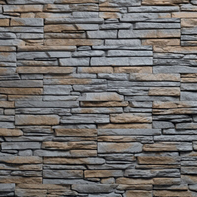 Superficie de revestimiento con textura de piedra en tonos grises y beige, presentando un acabado rústico y relieve irregular que imita la piedra natural Andorra Marengo.